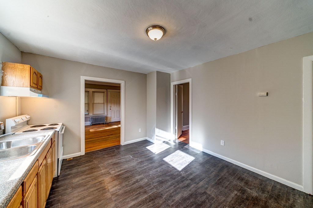 247-249 Commonwealth Avenue Springfield, MA 01108 - Photo 7 of 26 a kitchen with granite countertop a stove and a refrigerator