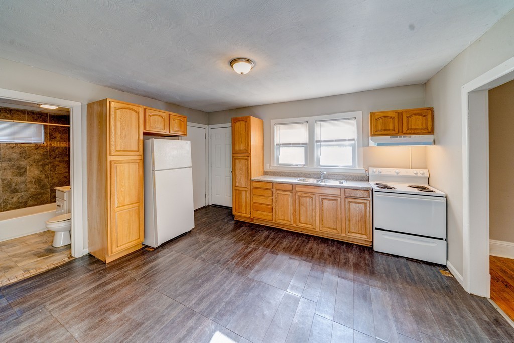 247-249 Commonwealth Avenue Springfield, MA 01108 - Photo 8 of 26 a view of a kitchen with wooden floor and a window