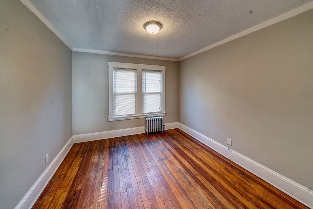 247-249 Commonwealth Avenue Springfield, MA 01108 - Photo 9 of 26 an empty room with wooden floor and windows