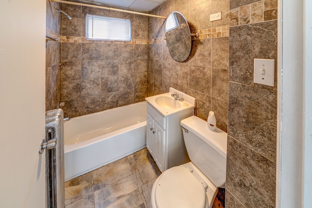 247-249 Commonwealth Avenue Springfield, MA 01108 - Photo 10 of 26 a bathroom with a toilet and a shower