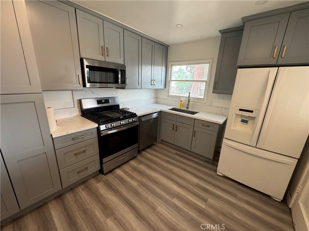 202 Spieth Way Riverside, CA 92507 - Photo 11 of 31 a kitchen with white cabinets and white appliances