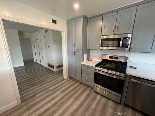 a kitchen with stainless steel appliances a stove a microwave and sink