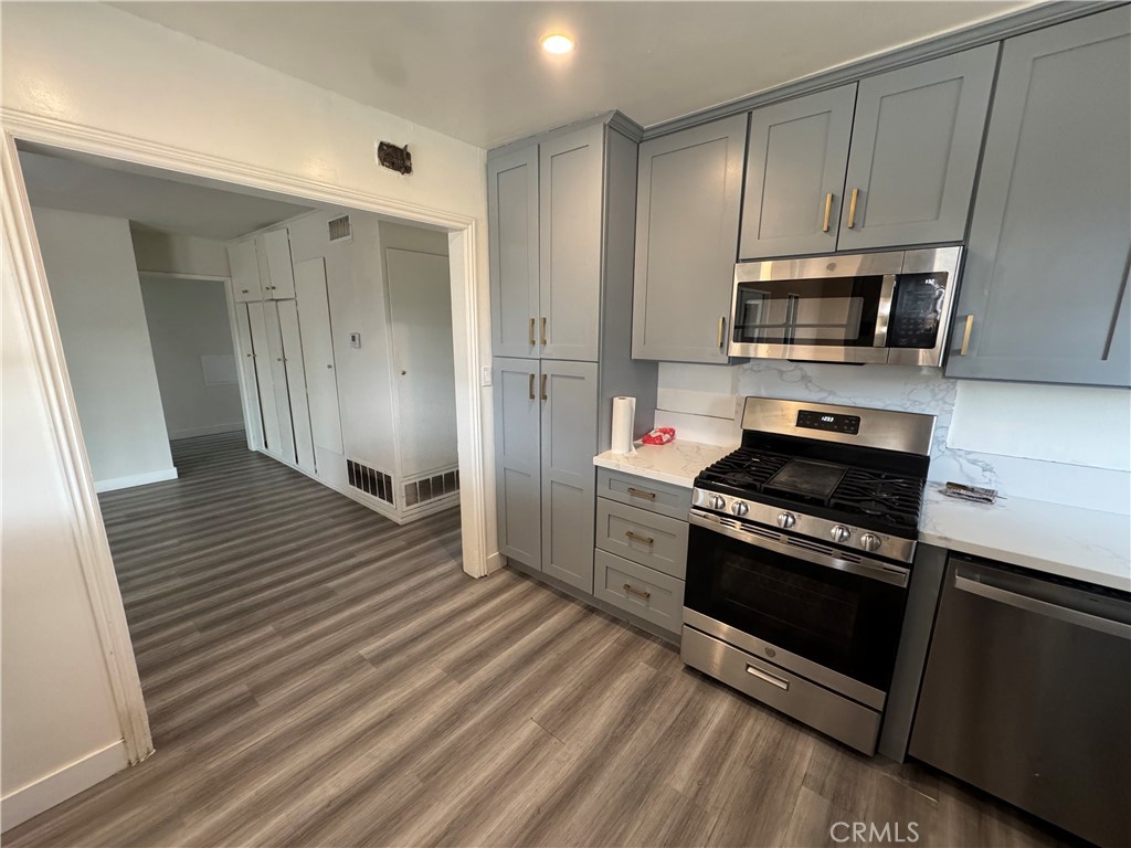 202 Spieth Way Riverside, CA 92507 - Photo 12 of 31 a kitchen with stainless steel appliances a stove a microwave and sink