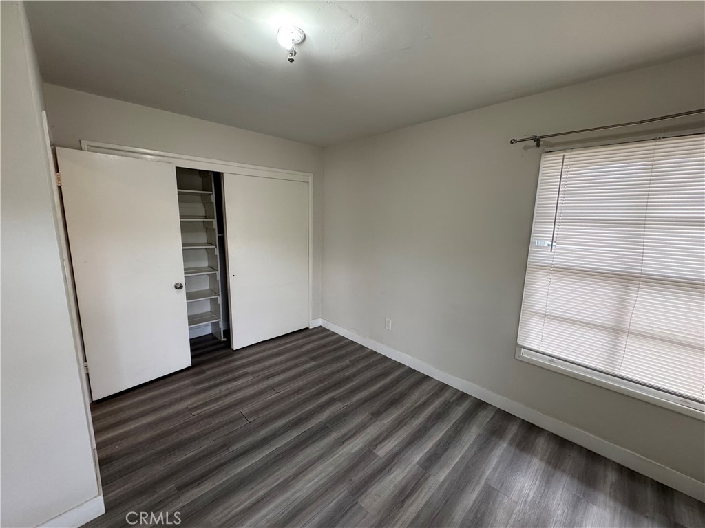 202 Spieth Way Riverside, CA 92507 - Photo 14 of 31 an empty room with wooden floor and windows