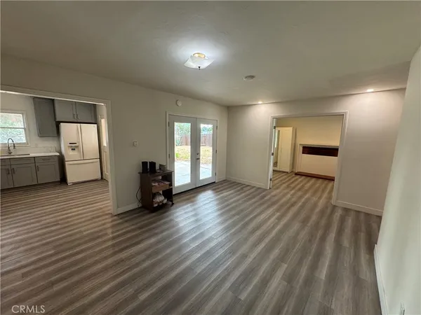 a view of a room with wooden floor and windows