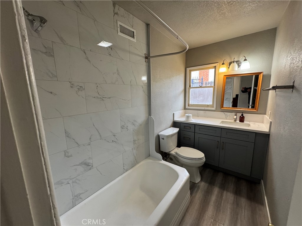 202 Spieth Way Riverside, CA 92507 - Photo 22 of 31 a bathroom with a double vanity sink toilet and shower