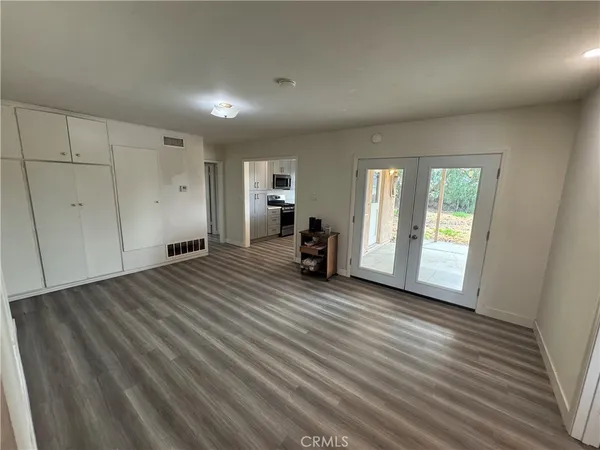 a view of a room with wooden floor and window