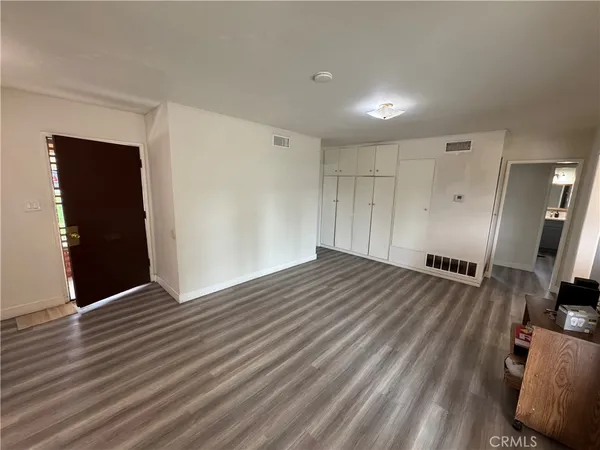 a view of a room with wooden floor