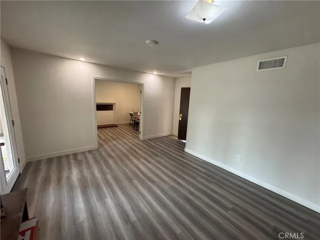 a view of a room with wooden floor