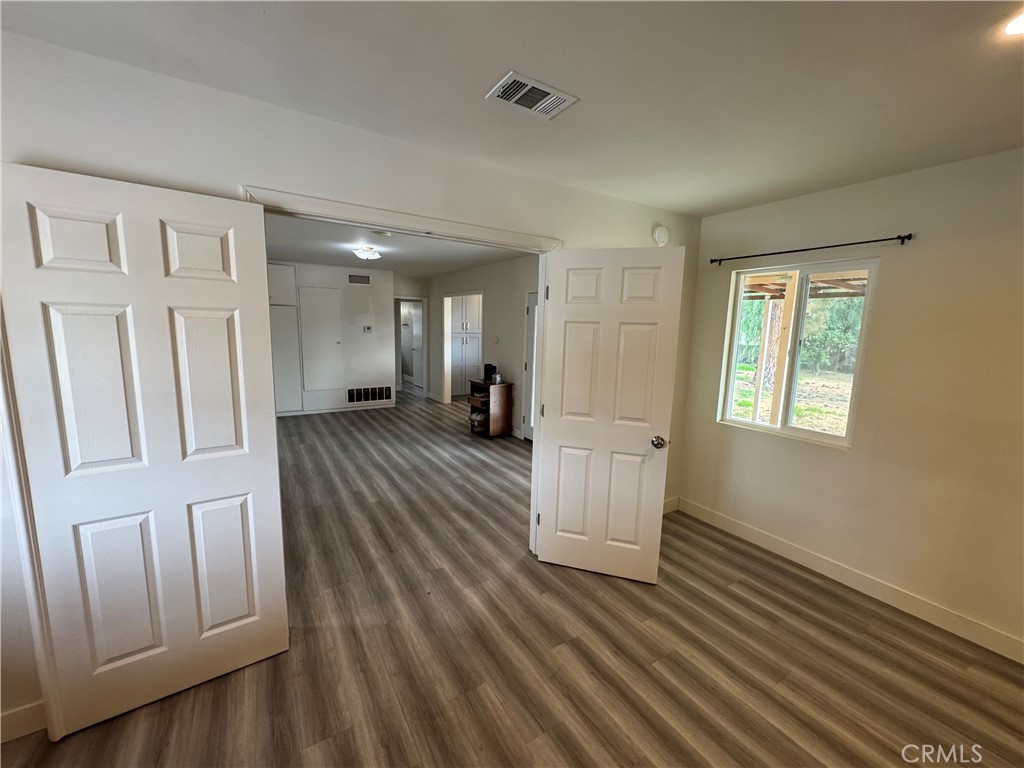 202 Spieth Way Riverside, CA 92507 - Photo 9 of 31 a view of a hallway with wooden floor and staircase