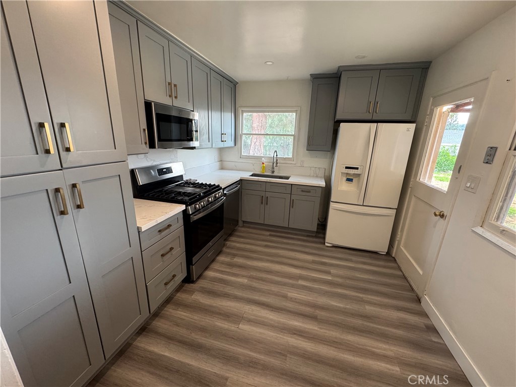 202 Spieth Way Riverside, CA 92507 - Photo 10 of 31 a kitchen with white cabinets and white appliances