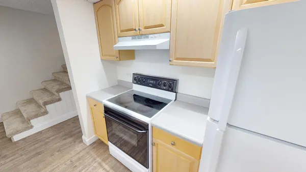 a kitchen with a stove top oven and cabinets
