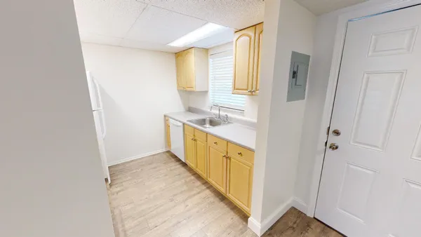 a view of a kitchen from the hallway