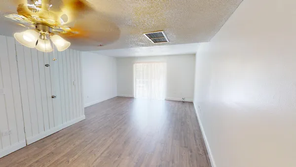 a view of a room with wooden floor