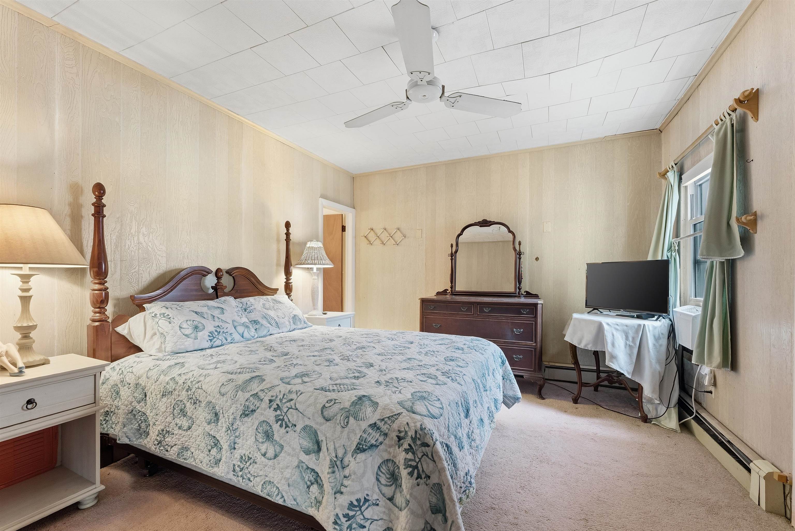 9727 3rd, Unit A1 Stone Harbor, NJ 08247 - Photo 19 of 20 a bedroom with a bed and a flat screen tv