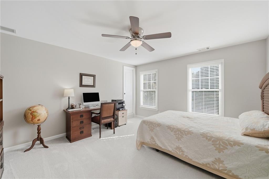 619 Blackwater Ridge Canton, GA 30114 - Photo 14 of 41 a bedroom with a bed gym equipment and a window