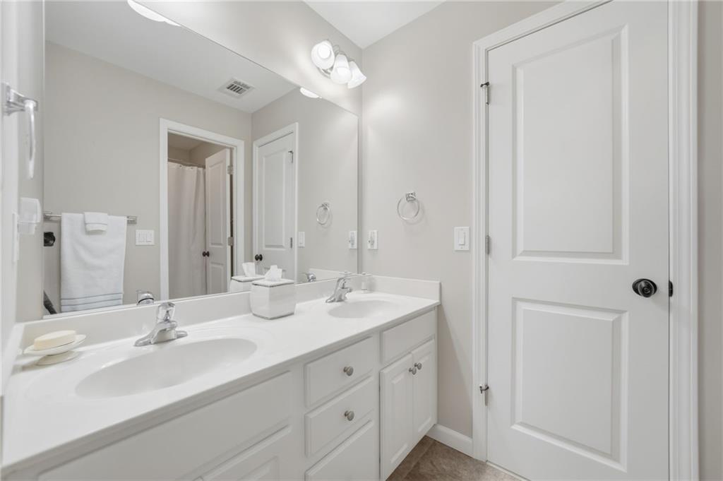 619 Blackwater Ridge Canton, GA 30114 - Photo 15 of 41 a bathroom with double vanity sinks and a mirror