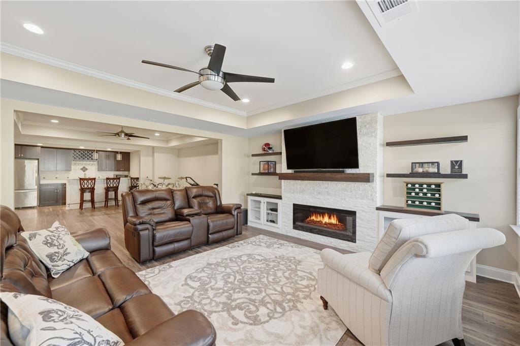 619 Blackwater Ridge Canton, GA 30114 - Photo 18 of 41 a living room with furniture a fireplace and a flat screen tv