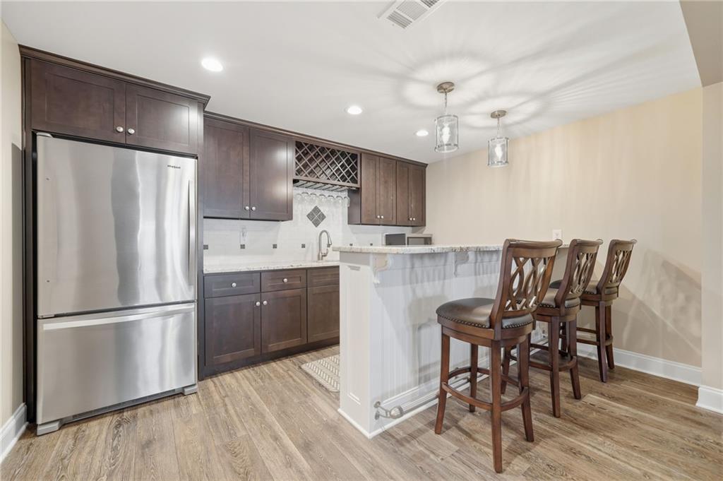 619 Blackwater Ridge Canton, GA 30114 - Photo 20 of 41 a kitchen with kitchen island white cabinets and stainless steel appliances