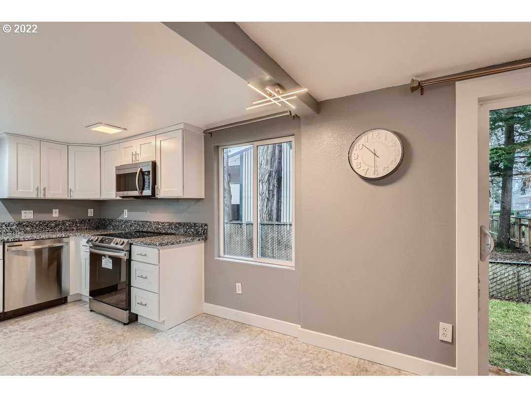 12603 Southeast Foster Road Portland, OR 97236 - Photo 15 of 28 a kitchen with stainless steel appliances granite countertop a stove a sink and a microwave