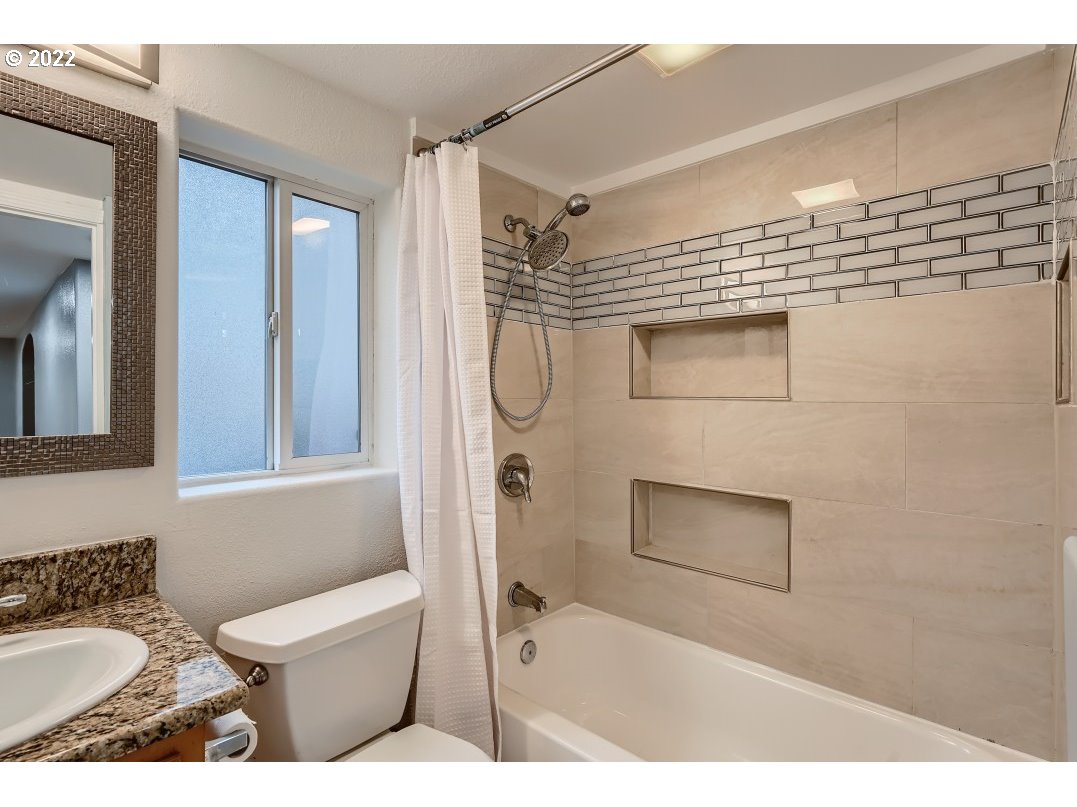 12603 Southeast Foster Road Portland, OR 97236 - Photo 16 of 28 a bathroom with a granite countertop sink a toilet and shower
