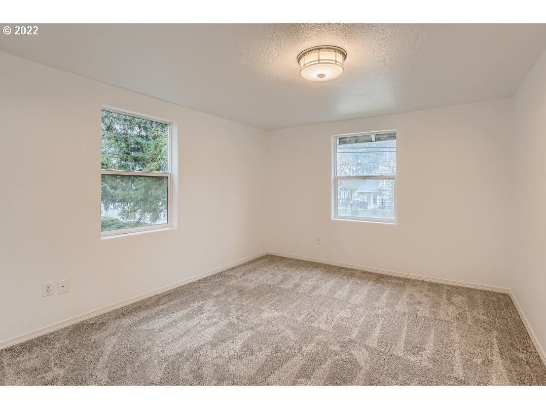 12603 Southeast Foster Road Portland, OR 97236 - Photo 17 of 28 an empty room with windows