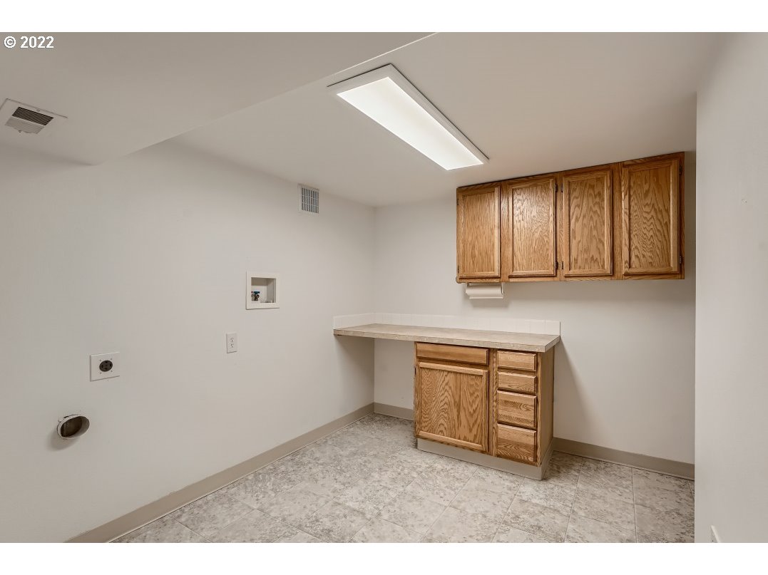 12603 Southeast Foster Road Portland, OR 97236 - Photo 25 of 28 a room with cabinets and window