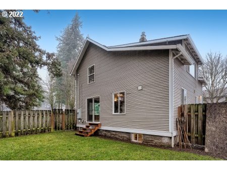 12603 Southeast Foster Road Portland, OR 97236 - Photo 3 of 28 a backyard of a house with table and chairs