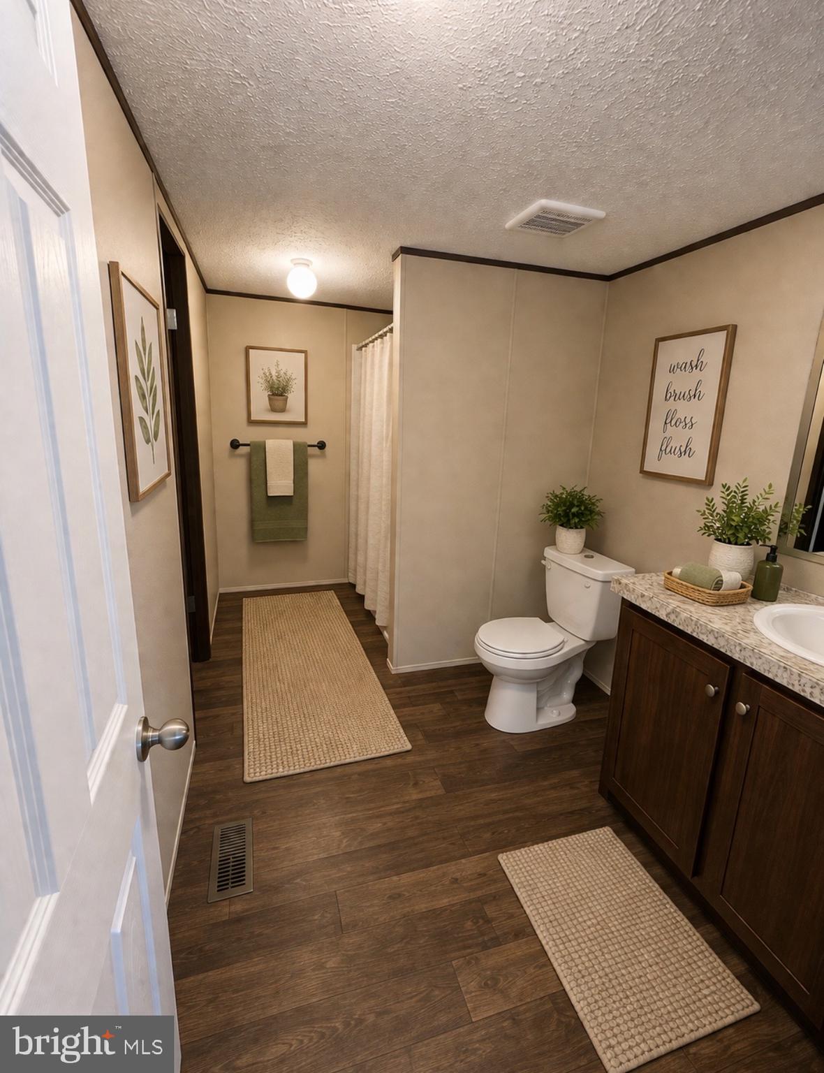 1555 Tavern Run Road Hague, VA 22469 - Photo 6 of 9 a bathroom with a toilet a sink and mirror