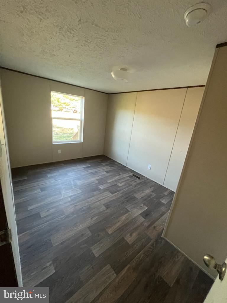 1555 Tavern Run Road Hague, VA 22469 - Photo 7 of 9 an empty room with wooden floor and windows