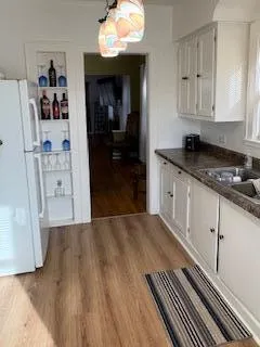 a kitchen with stainless steel appliances granite countertop a refrigerator and a stove top oven