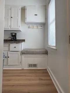 a kitchen with granite countertop white cabinets and white appliances