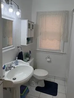 a bathroom with a sink toilet and mirror