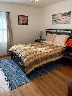 a bed sitting in a bedroom next to a window