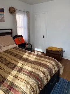 a bedroom with two beds and a window