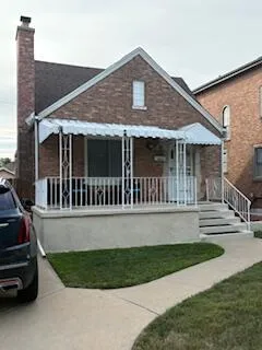 a front view of a house with a yard table and chairs