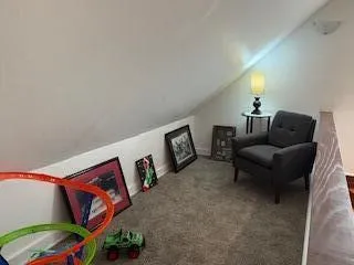 a living room with furniture and a wall painting