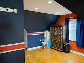 a view of an empty room with wooden floor