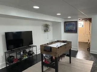 a view of a livingroom with furniture and a flat screen tv