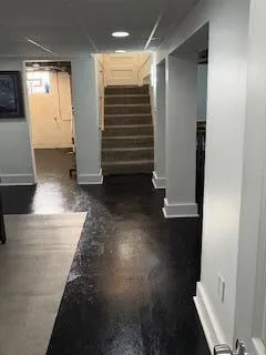 wooden floor in an empty room and a bathroom
