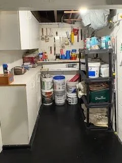 a kitchen with stainless steel appliances a stove a sink and white cabinets