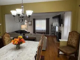 a living room with fireplace furniture and a chandelier