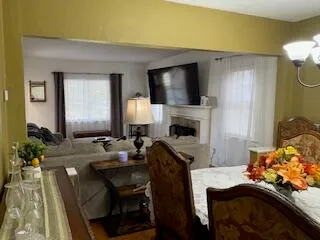 a living room with furniture fireplace and a flat screen tv
