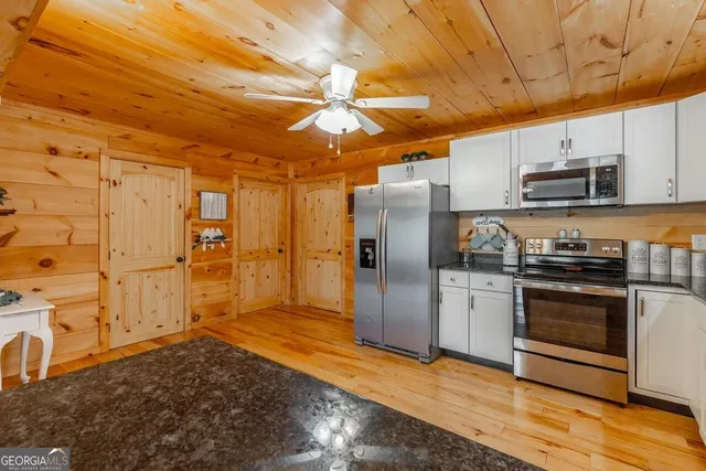 a view of a patio with dining table and chairs with wooden floor and fence