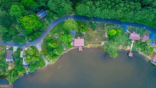 an aerial view of a house with a yard and outdoor seating