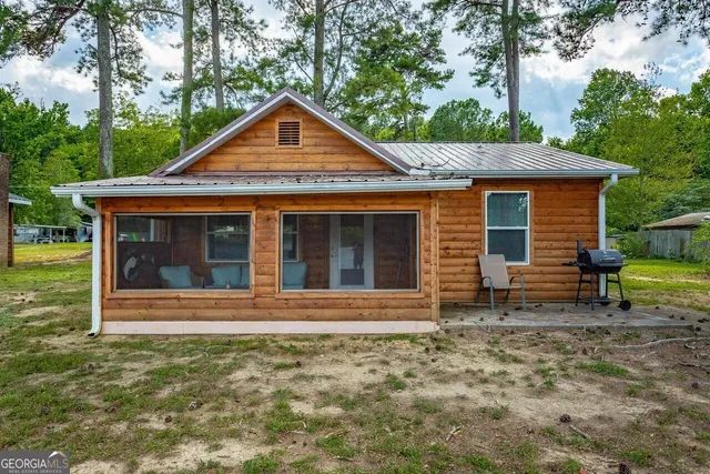 a view of a deck with furniture and garden