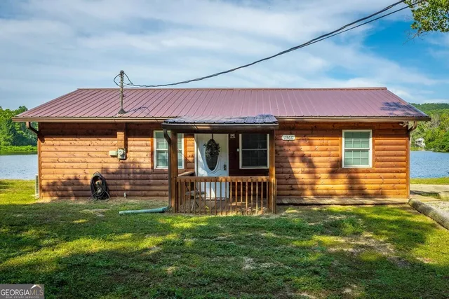 a view of a two chair in the balcony next to a yard