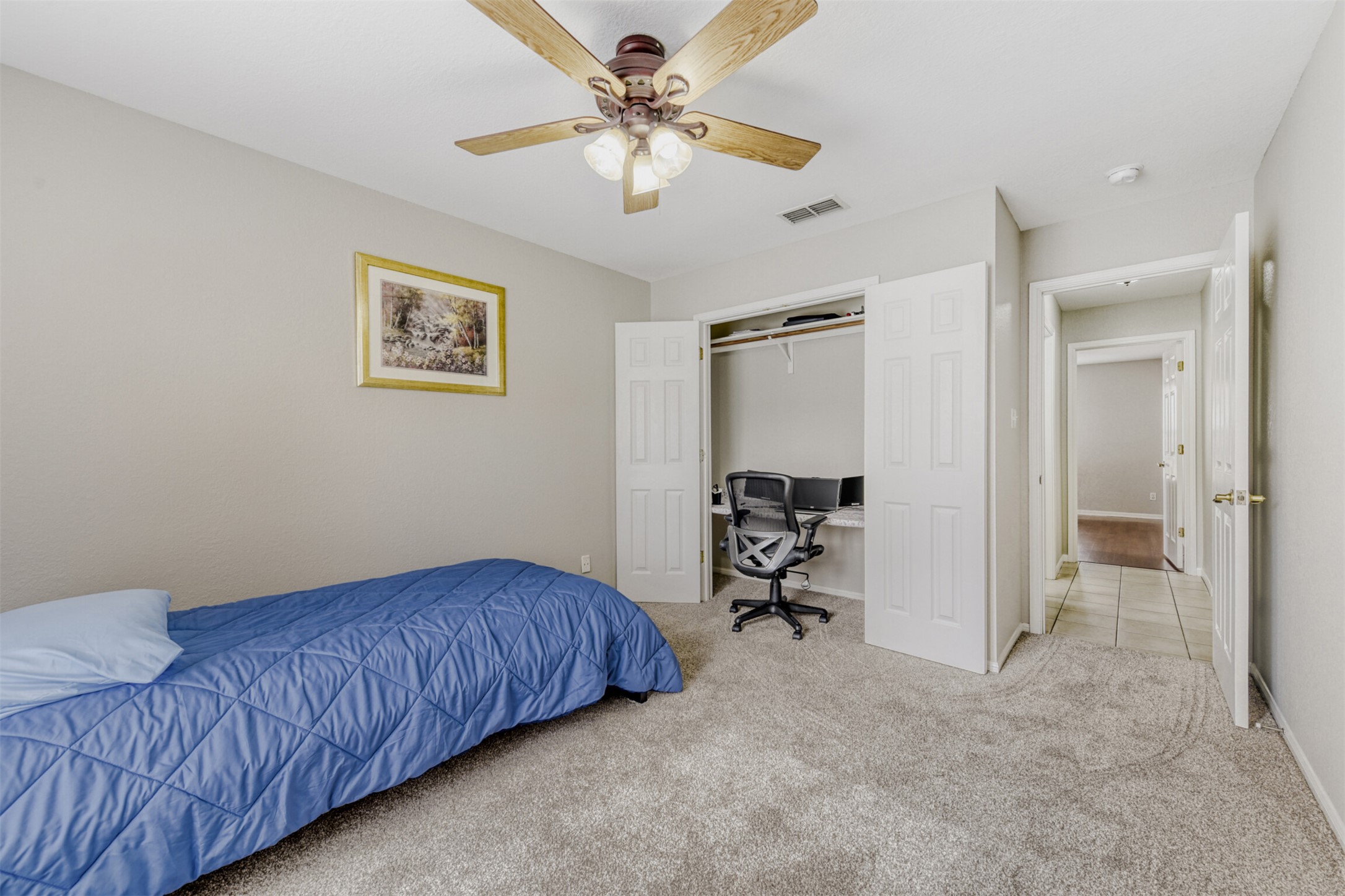 104 Spring Branch Bastrop, TX 78602 - Photo 27 of 32 Carpeted bedroom featuring a ceiling fan, a closet, and an office area