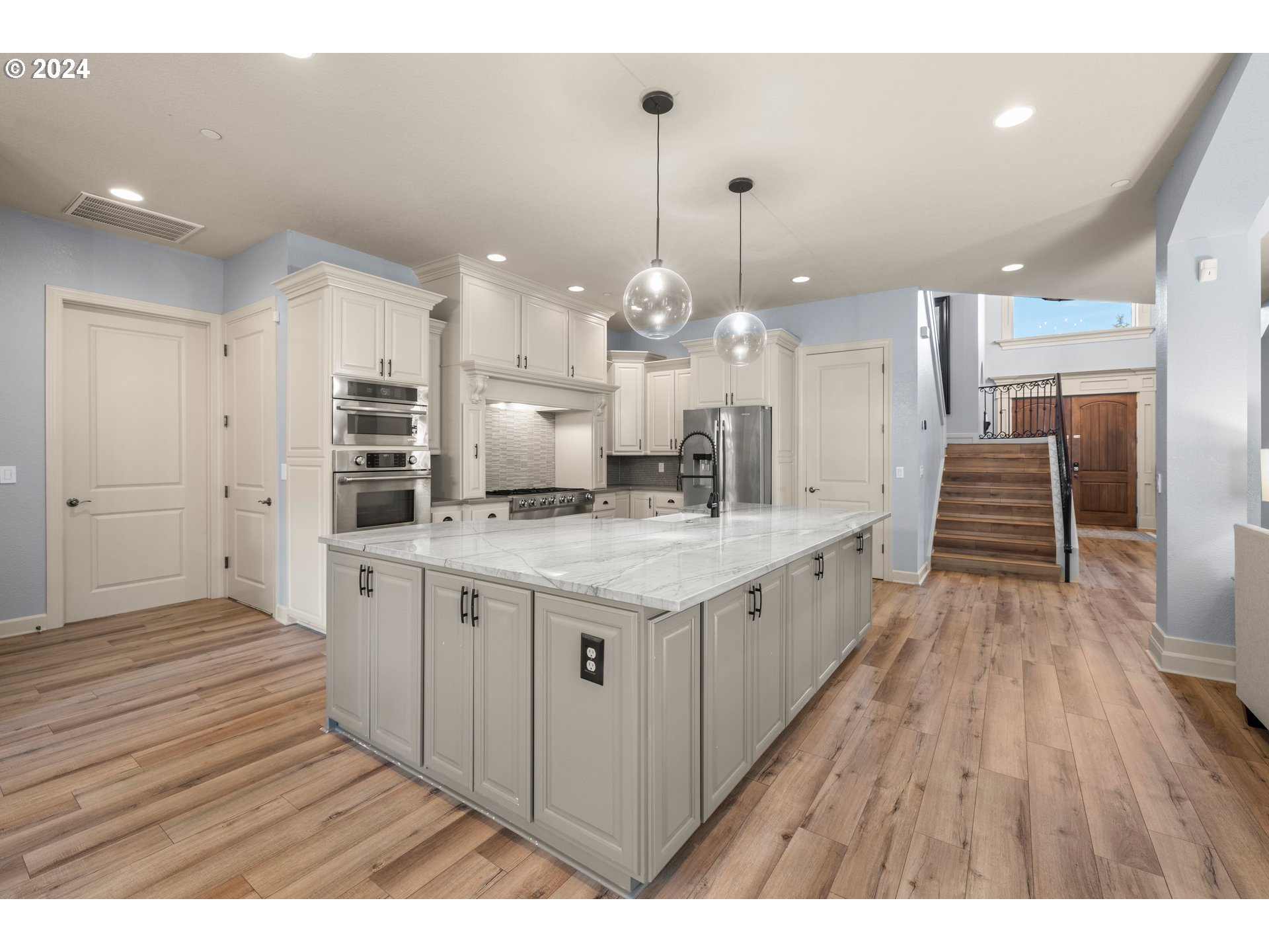 606 Northwest 24th Circle Camas, WA 98607 - Photo 13 of 48 a large kitchen with granite countertop a large counter top a sink stainless steel appliances and cabinets