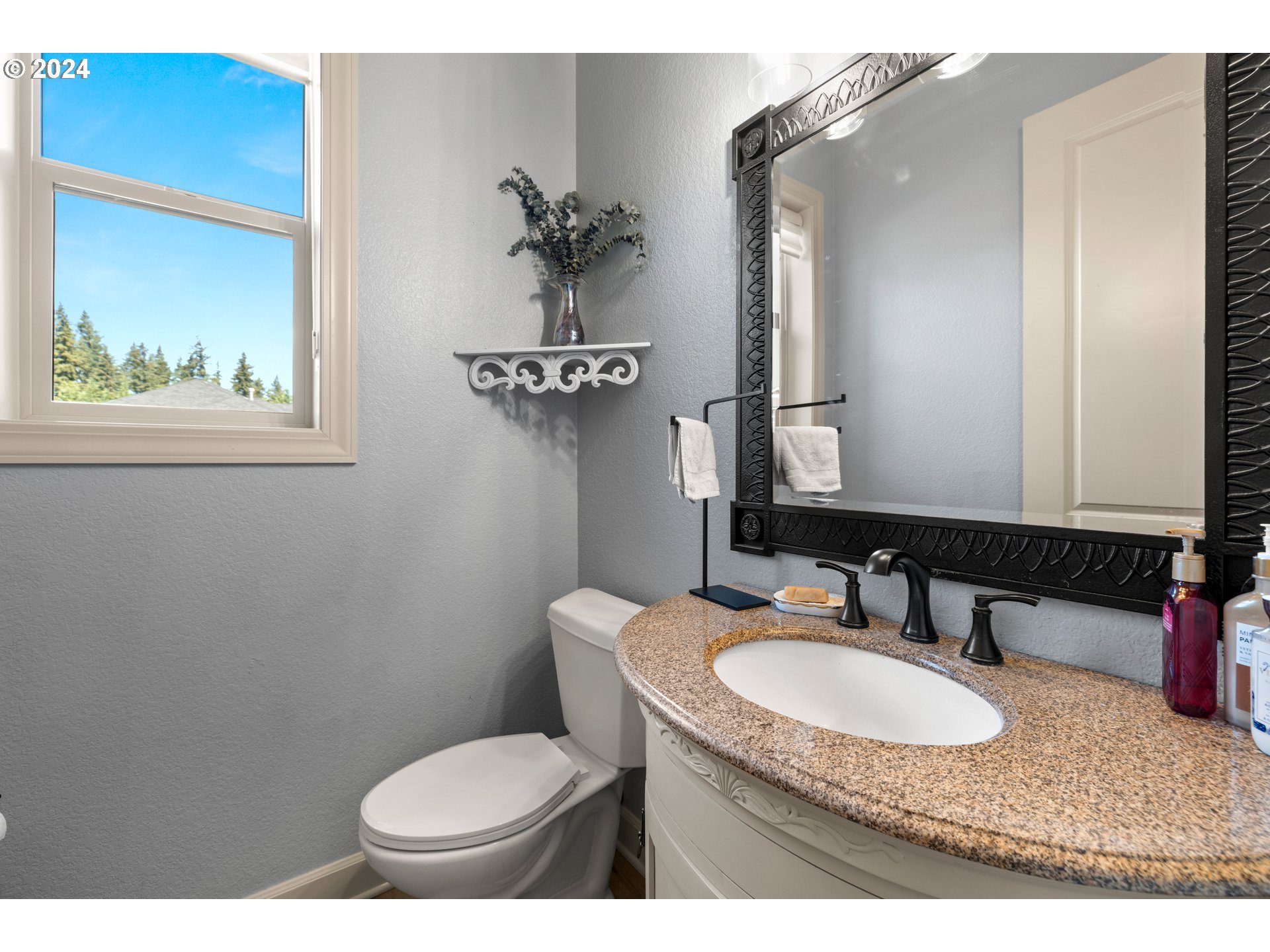 606 Northwest 24th Circle Camas, WA 98607 - Photo 19 of 48 a bathroom with a granite countertop toilet sink and mirror